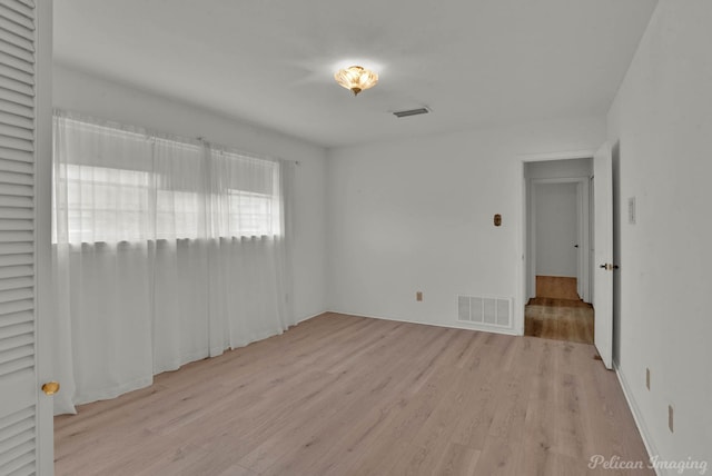 spare room featuring light wood-type flooring