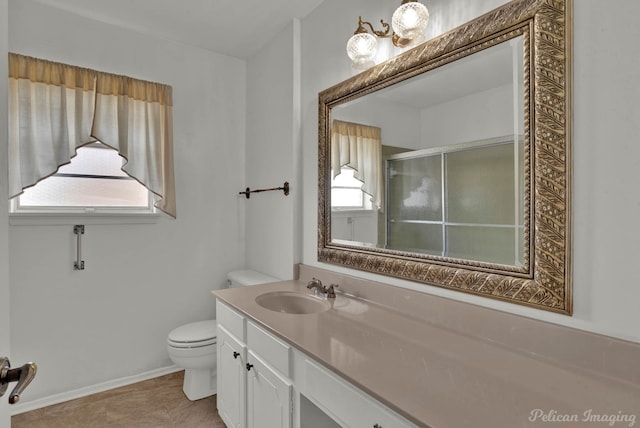 bathroom with a shower with door, vanity, and toilet