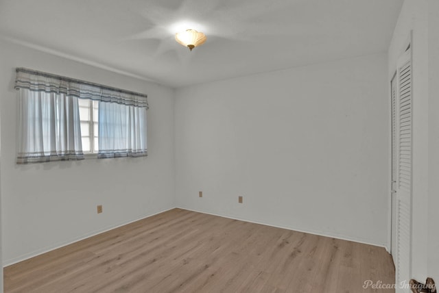 unfurnished bedroom with a closet and light hardwood / wood-style flooring