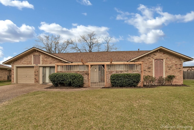 ranch-style house featuring a garage and a front yard