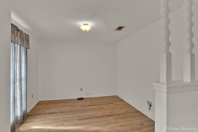 unfurnished room with light wood-type flooring