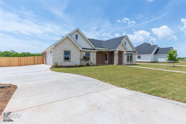 145 Colorado, Abilene, TX 79606 - view of front of property featuring board and batten siding, concrete driveway, stone siding, and roof with shingles