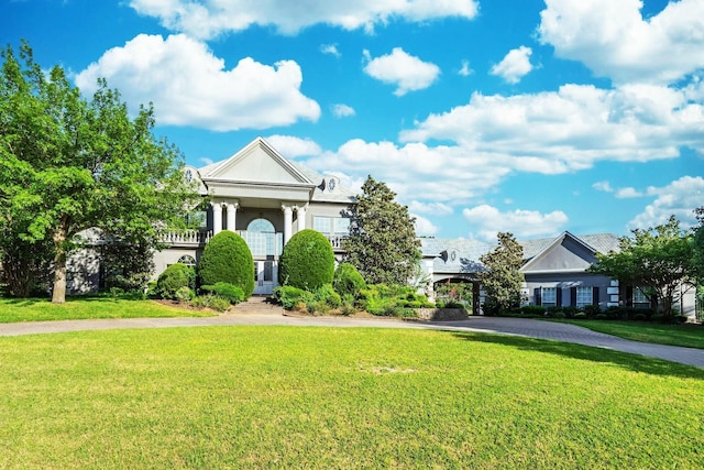 neoclassical home with a front yard