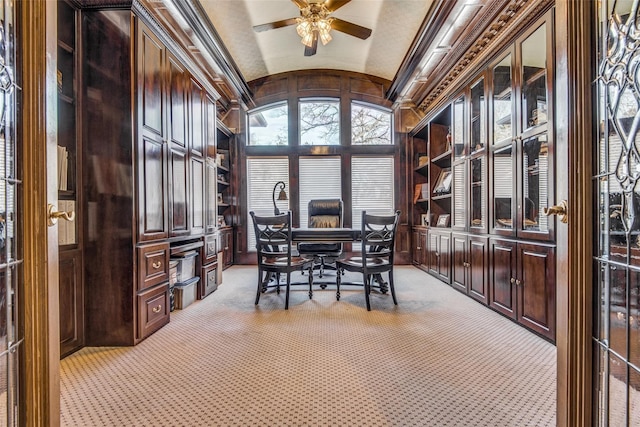 carpeted office space with ceiling fan, wood walls, lofted ceiling, and brick ceiling