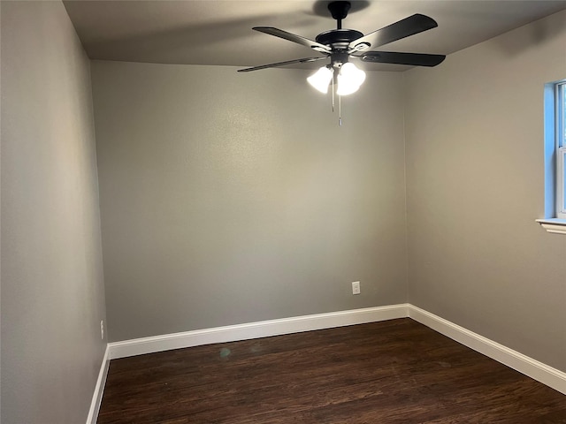 spare room featuring dark wood-type flooring and ceiling fan