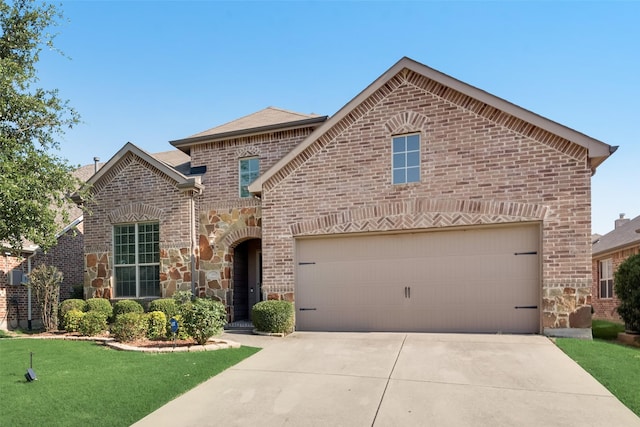 front facade featuring a front yard and a garage