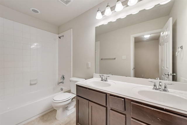 full bathroom featuring tile patterned flooring, vanity, tiled shower / bath combo, and toilet