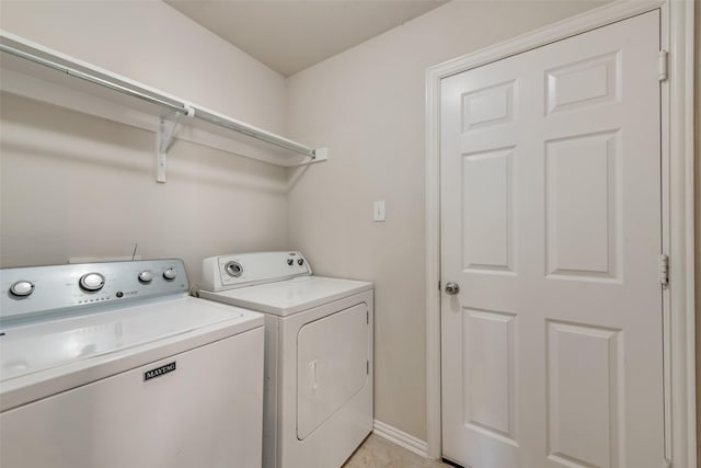 laundry room featuring washer and dryer and light tile patterned flooring