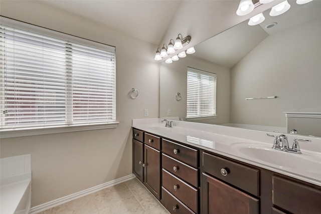 bathroom featuring a tub, tile patterned flooring, vanity, and vaulted ceiling