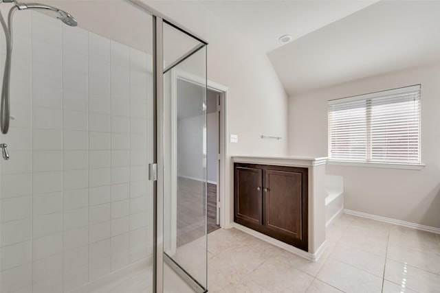 bathroom with tile patterned flooring, separate shower and tub, and lofted ceiling