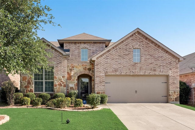 view of front property featuring a front yard and a garage