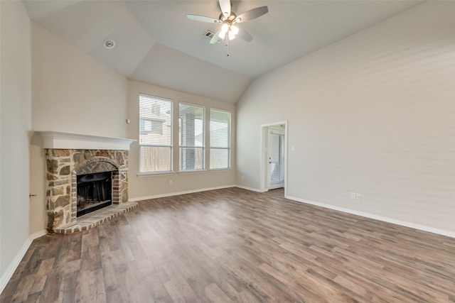 unfurnished living room with ceiling fan, wood-type flooring, lofted ceiling, and a fireplace