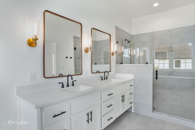 bathroom featuring vanity, tile patterned floors, and a shower with shower door