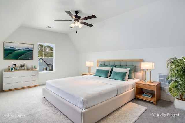bedroom featuring vaulted ceiling, light colored carpet, and ceiling fan