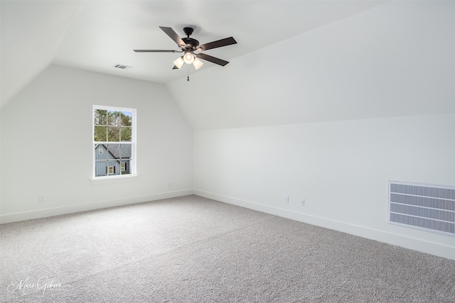 additional living space with lofted ceiling, ceiling fan, and carpet flooring
