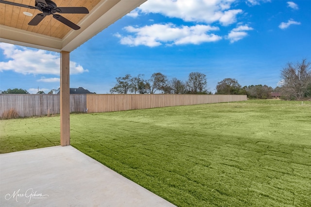 view of yard with ceiling fan and a patio area