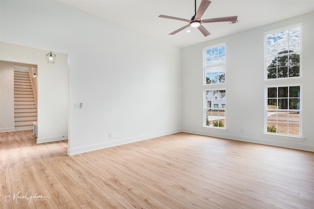 spare room featuring ceiling fan and light hardwood / wood-style flooring