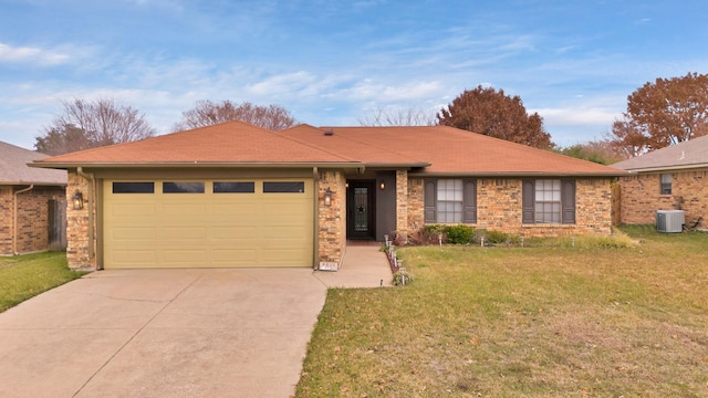 ranch-style home featuring a garage, a front yard, and central AC