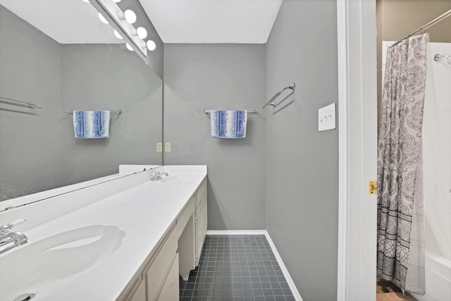 bathroom featuring tile patterned flooring, vanity, a textured ceiling, and shower / tub combo