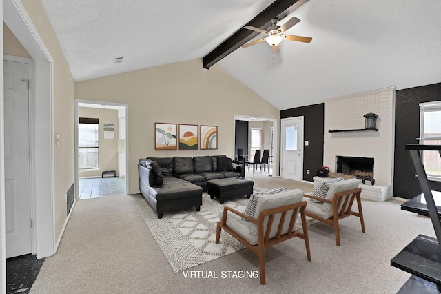 carpeted living room with vaulted ceiling with beams, a fireplace, plenty of natural light, and a textured ceiling