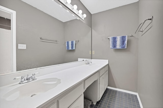 bathroom featuring a textured ceiling and vanity