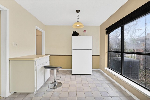 dining room with a textured ceiling and light carpet