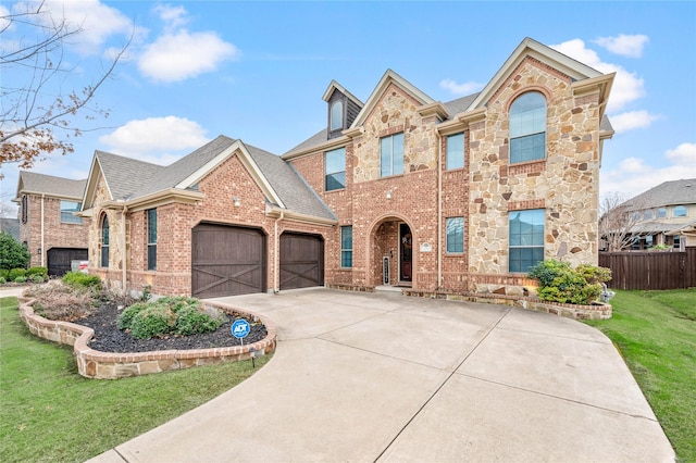 view of front of property featuring a front lawn and a garage