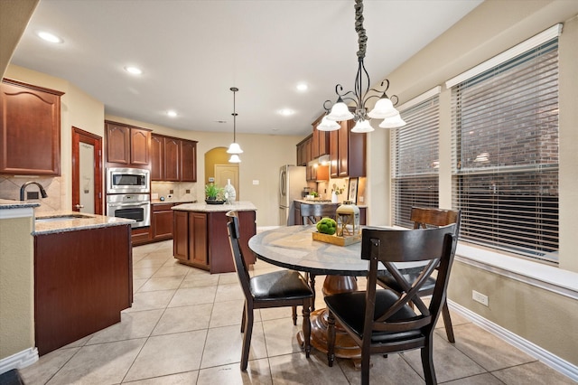 tiled dining room featuring sink