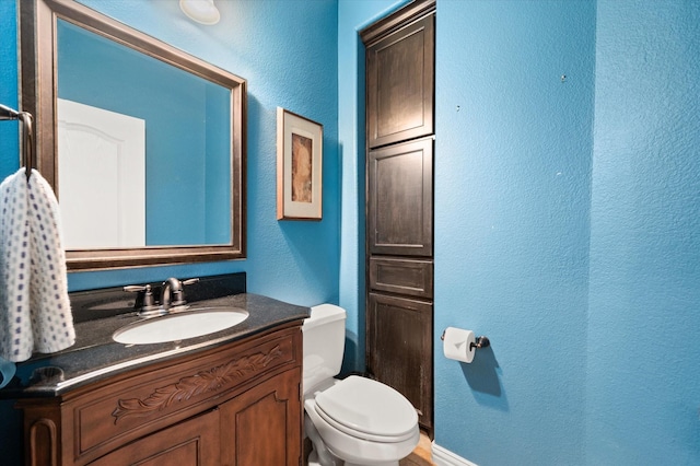 bathroom with toilet and vanity