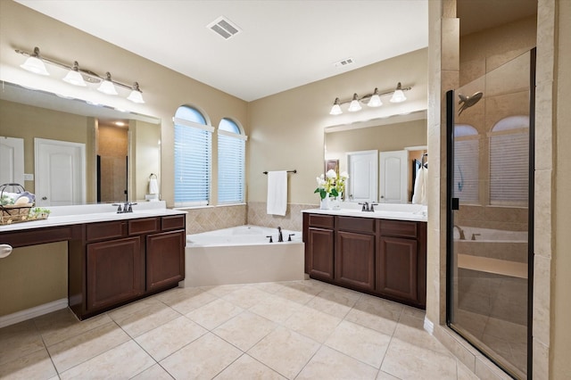 bathroom featuring plus walk in shower, tile patterned floors, and vanity