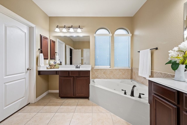 bathroom with vanity, tile patterned flooring, and a bath