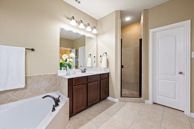 bathroom with independent shower and bath, tile patterned flooring, and vanity