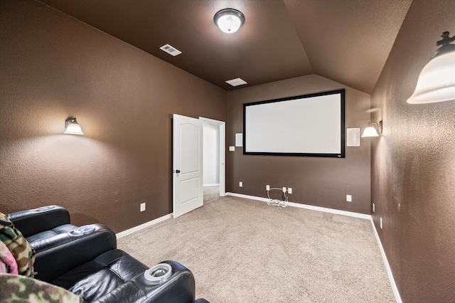 carpeted home theater with vaulted ceiling