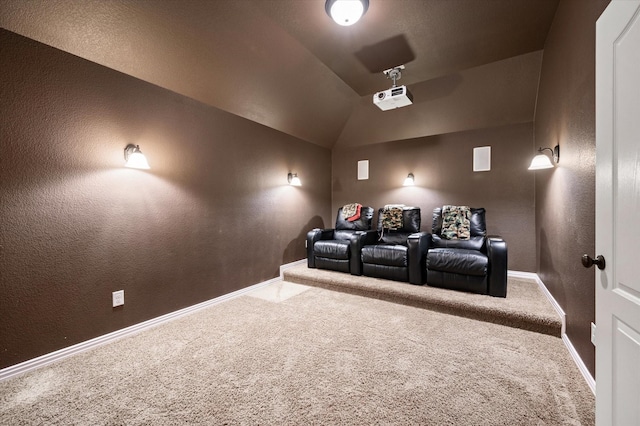 carpeted home theater room with lofted ceiling