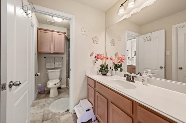 bathroom featuring toilet and vanity