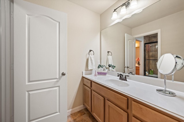 bathroom with vanity and a shower with door