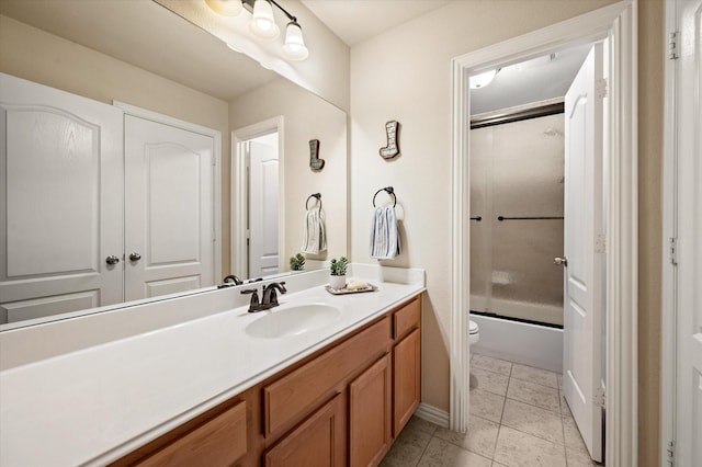 full bathroom featuring toilet, combined bath / shower with glass door, tile patterned flooring, and vanity