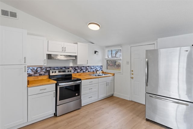 kitchen featuring white cabinetry, wooden counters, extractor fan, and appliances with stainless steel finishes