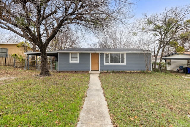 view of front of house with a carport and a front lawn