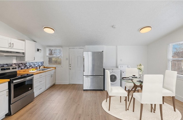 kitchen with sink, white cabinets, stainless steel appliances, and washer / dryer