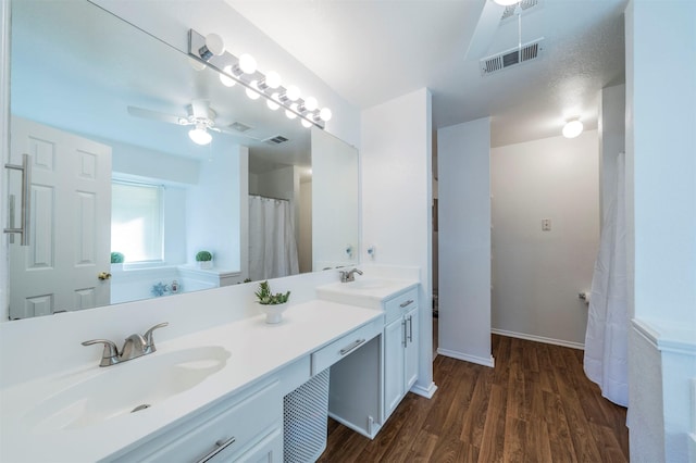 bathroom with hardwood / wood-style floors, vanity, a textured ceiling, and ceiling fan