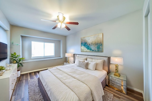 bedroom with ceiling fan and dark wood-type flooring