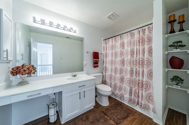 bathroom with vanity, toilet, and wood-type flooring