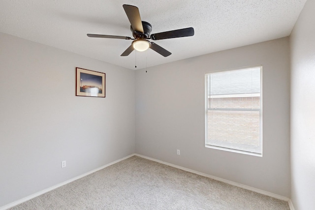 unfurnished room featuring ceiling fan, a textured ceiling, and carpet flooring