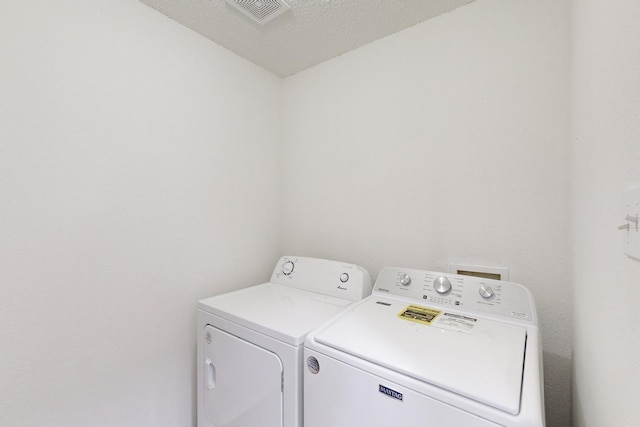 clothes washing area with independent washer and dryer