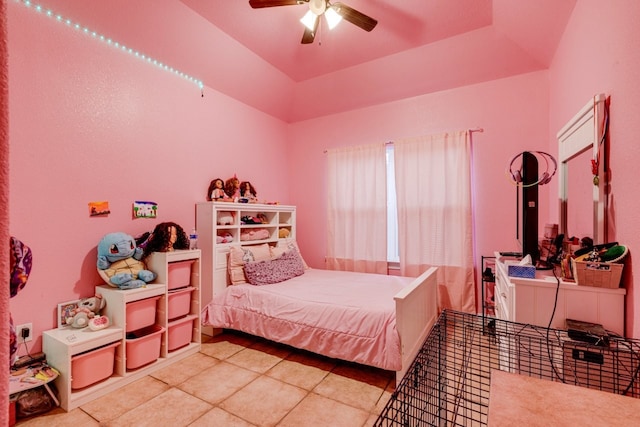 tiled bedroom featuring ceiling fan and a raised ceiling