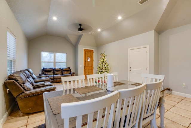 dining room with ceiling fan, light tile patterned flooring, and lofted ceiling