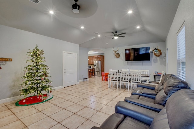 living room with ceiling fan, lofted ceiling, and light tile patterned floors