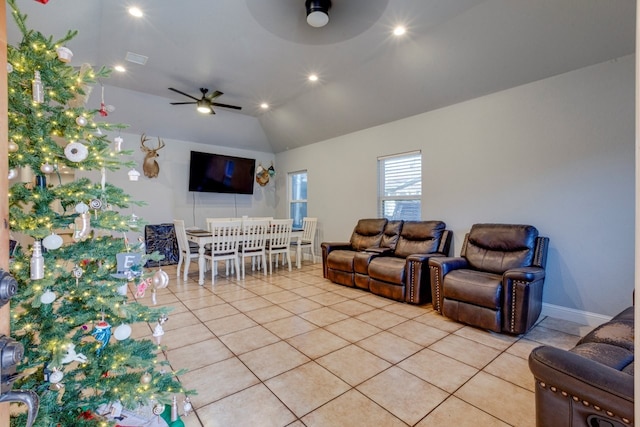 tiled living room with ceiling fan and vaulted ceiling