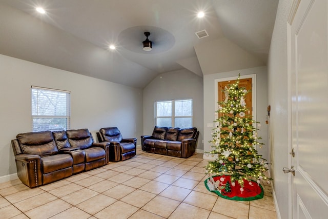 living room featuring ceiling fan, a healthy amount of sunlight, vaulted ceiling, and light tile patterned floors